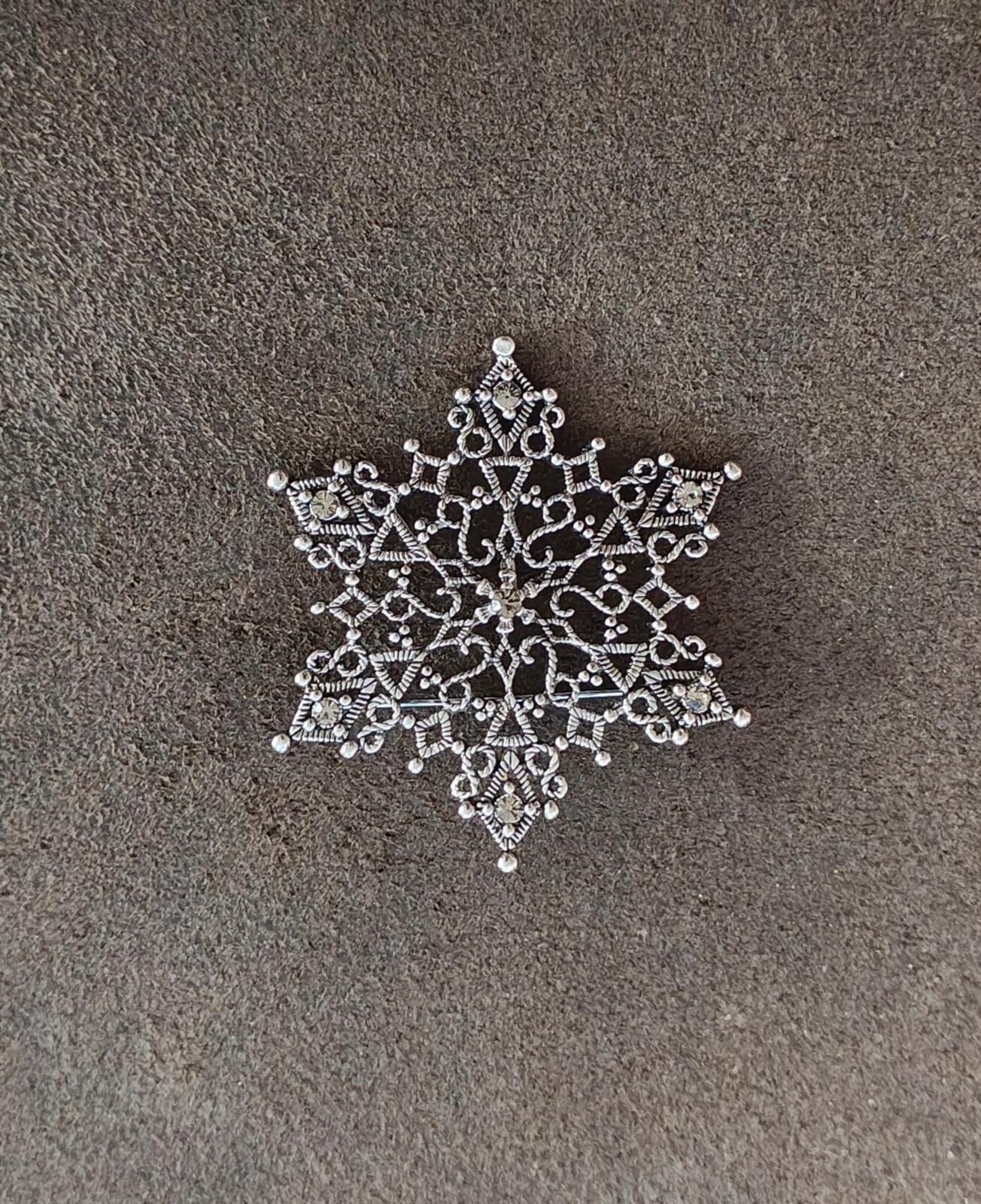 1990s Silver Tone Filigree Snowflake With Clear Rhinestone Accents Brooch.