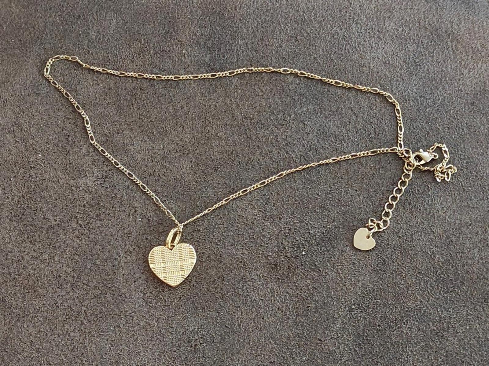 Gold tone heart pendant necklace with small heart charms on chain