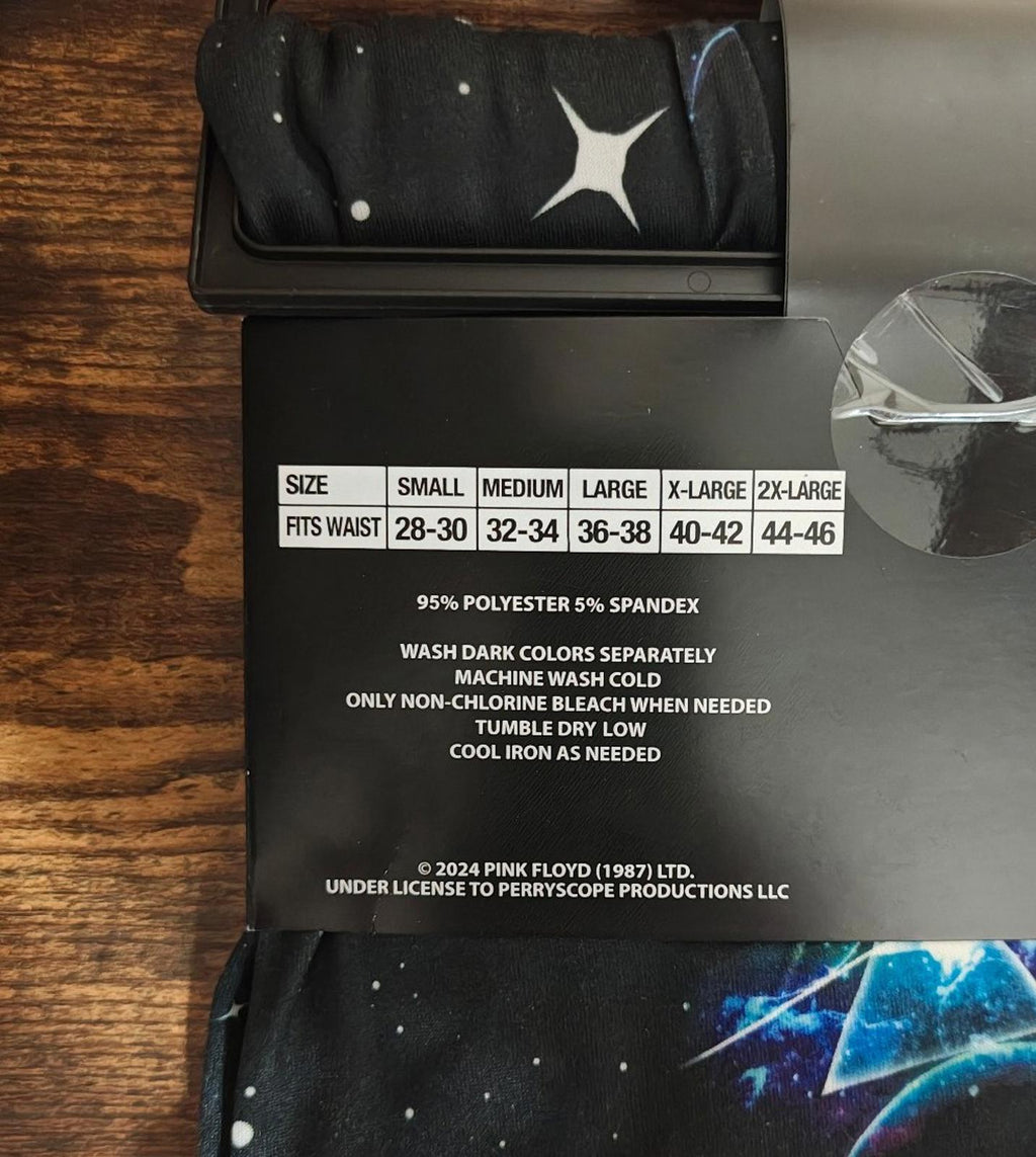 Black sleep pants fabric and care label window; white star icon on waistband