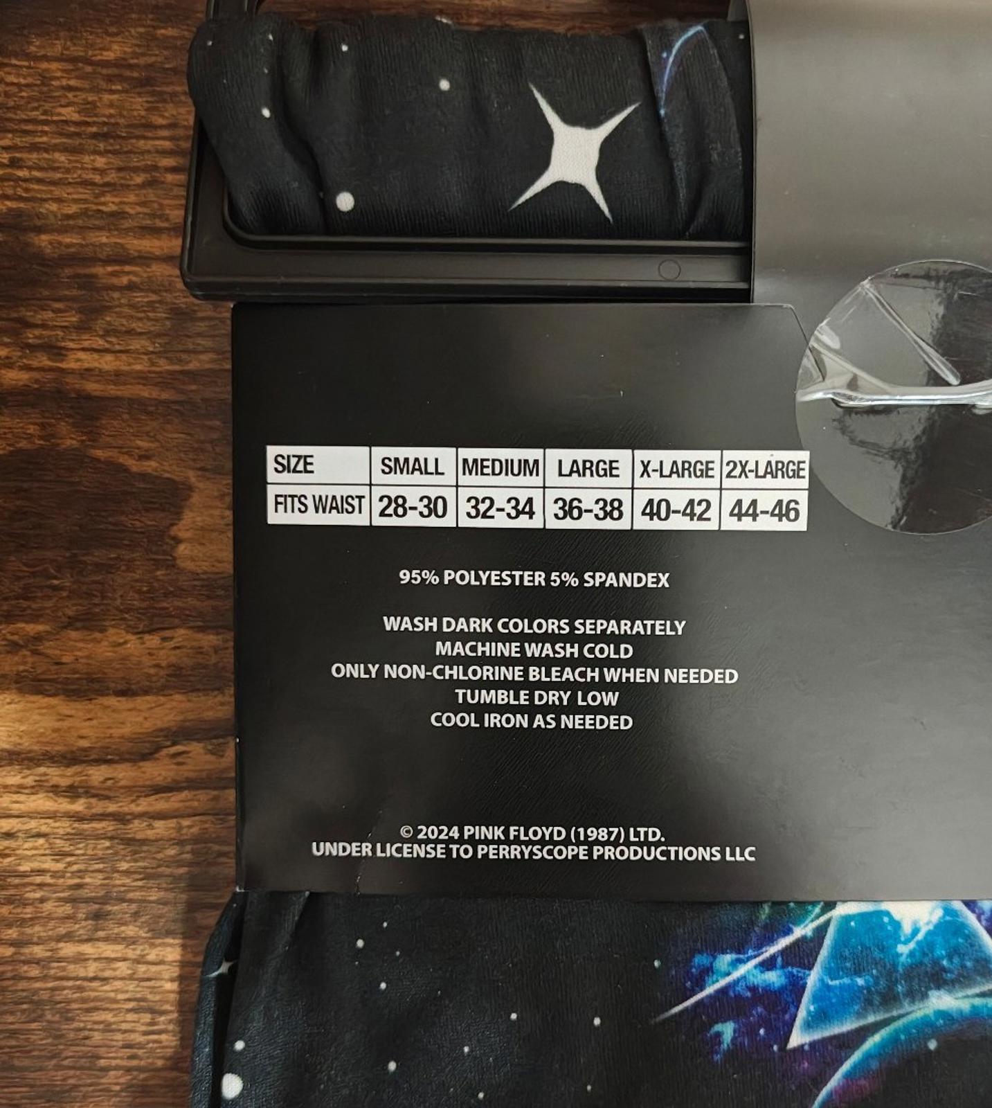 Black sleep pants fabric and care label window; white star icon on waistband