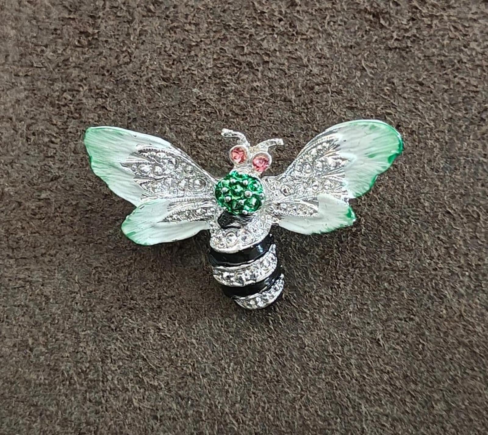 Bee enamel brooch featuring mint green wings, green center stones, pink rhinestone accents