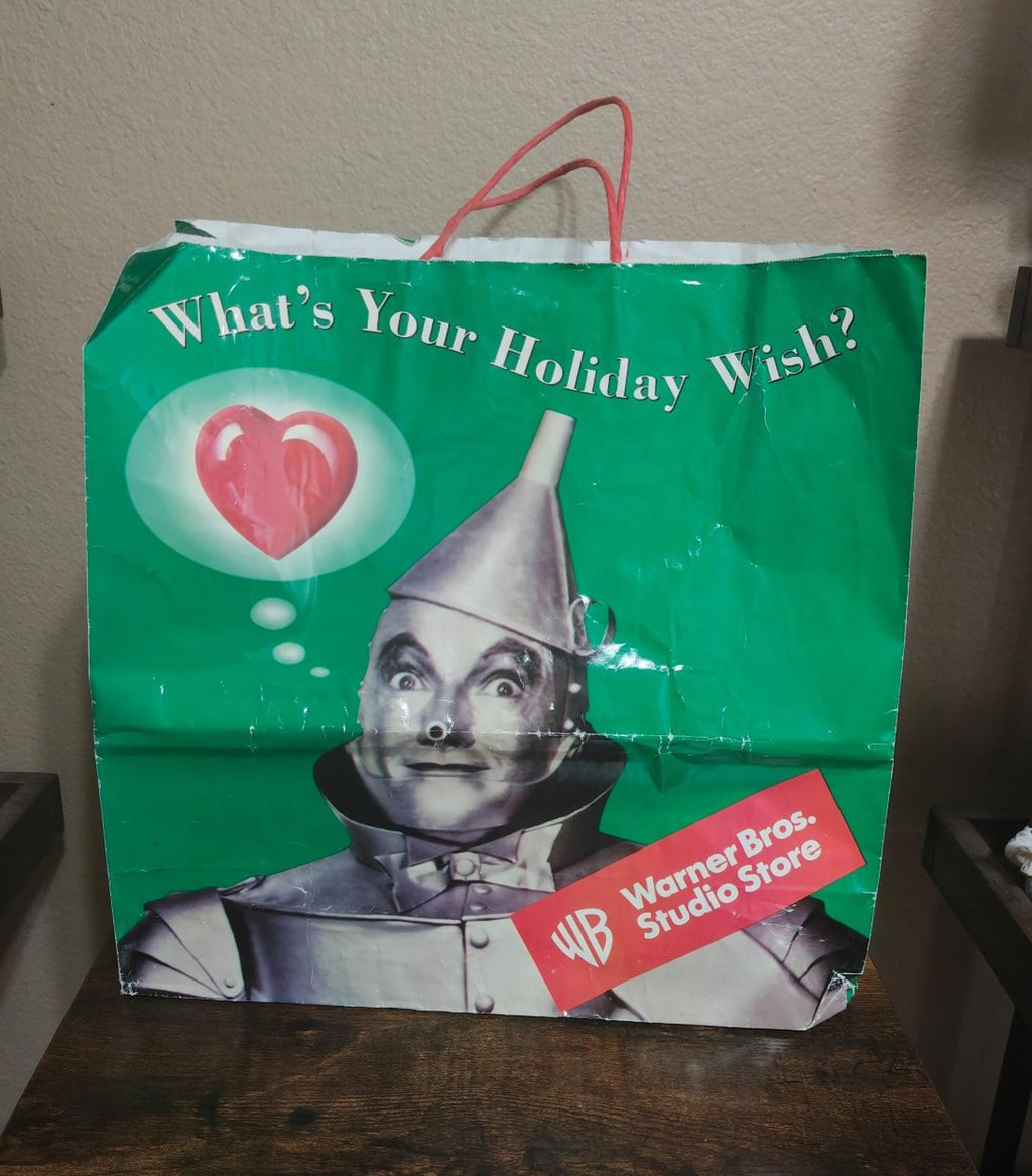 Green paper shopping bag with “What’s Your Holiday Wish!” and Wicked Witch image