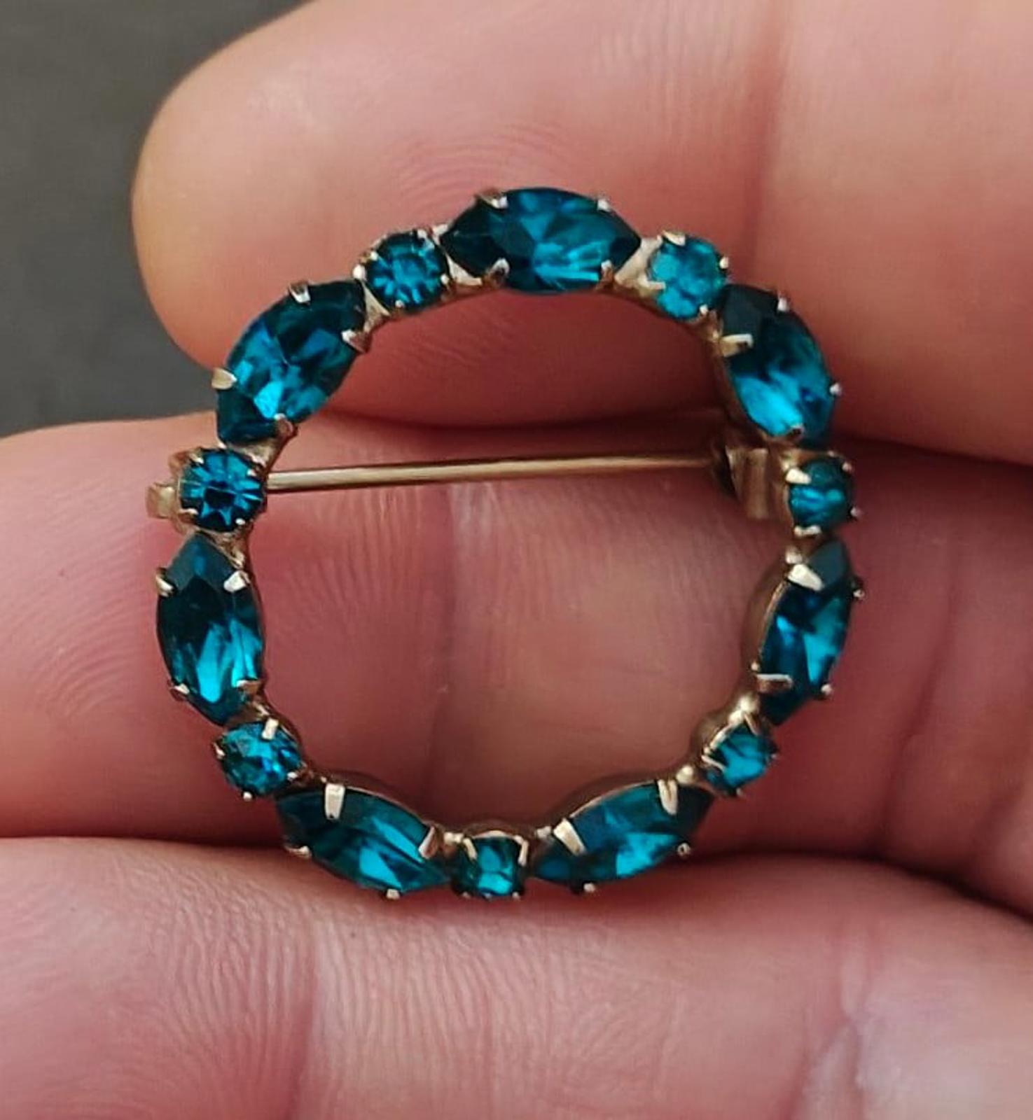 Aqua blue rhinestone circular brooch pin with round stones and gold-tone bar clasp
