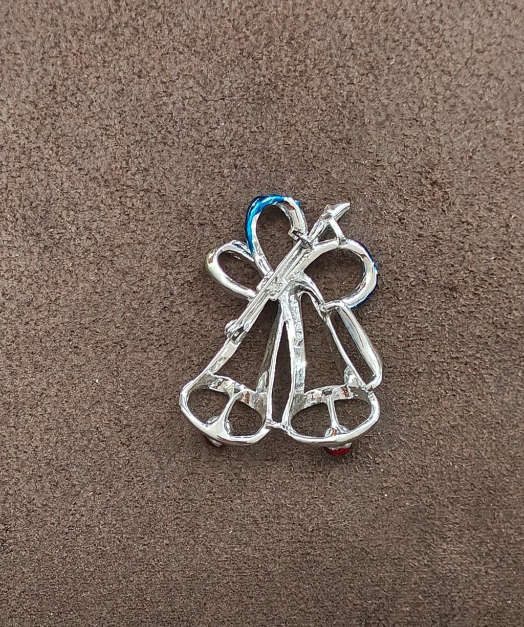Silver-tone bell Christmas brooch pin with bow-like ribbon loops and curved base