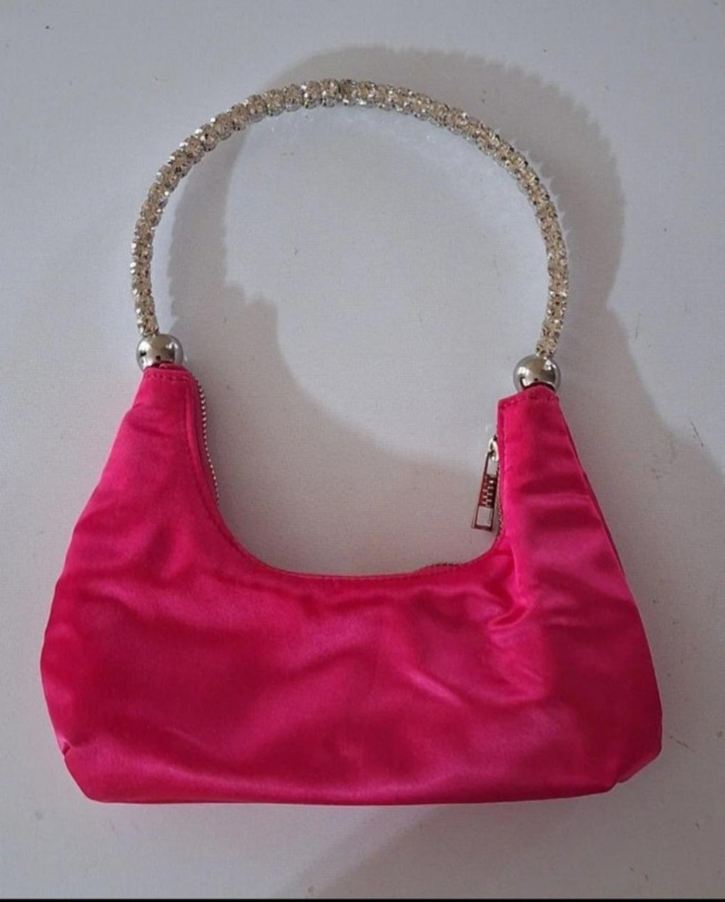 Pink satin mini hobo purse with curved rhinestone handle and zip closure