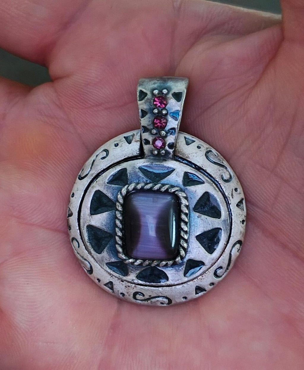 Silver Southwest-style pendant with purple stone center and pink cluster accents
