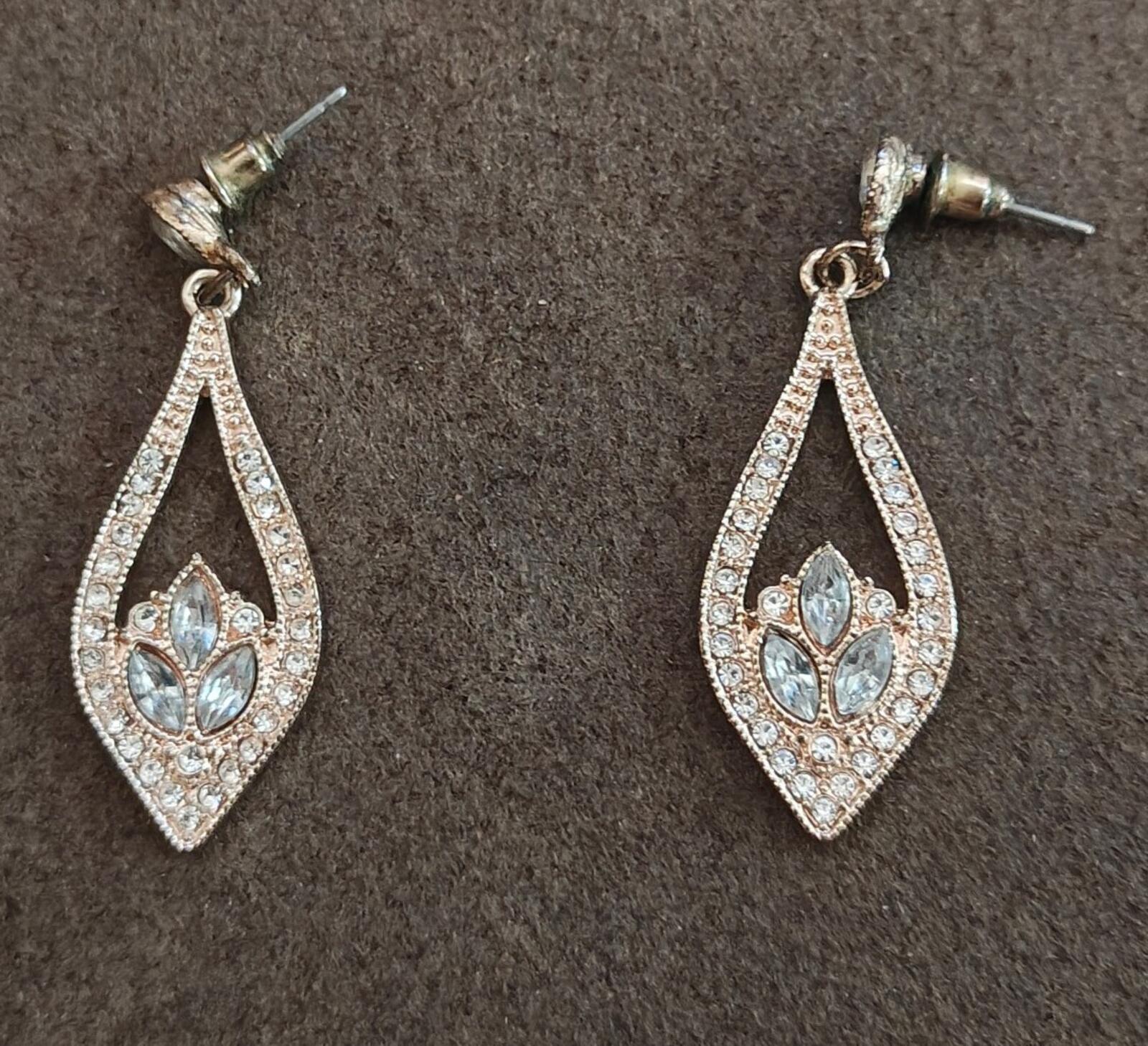 Crystal teardrop dangle earrings with light blue center stones, silver-tone settings