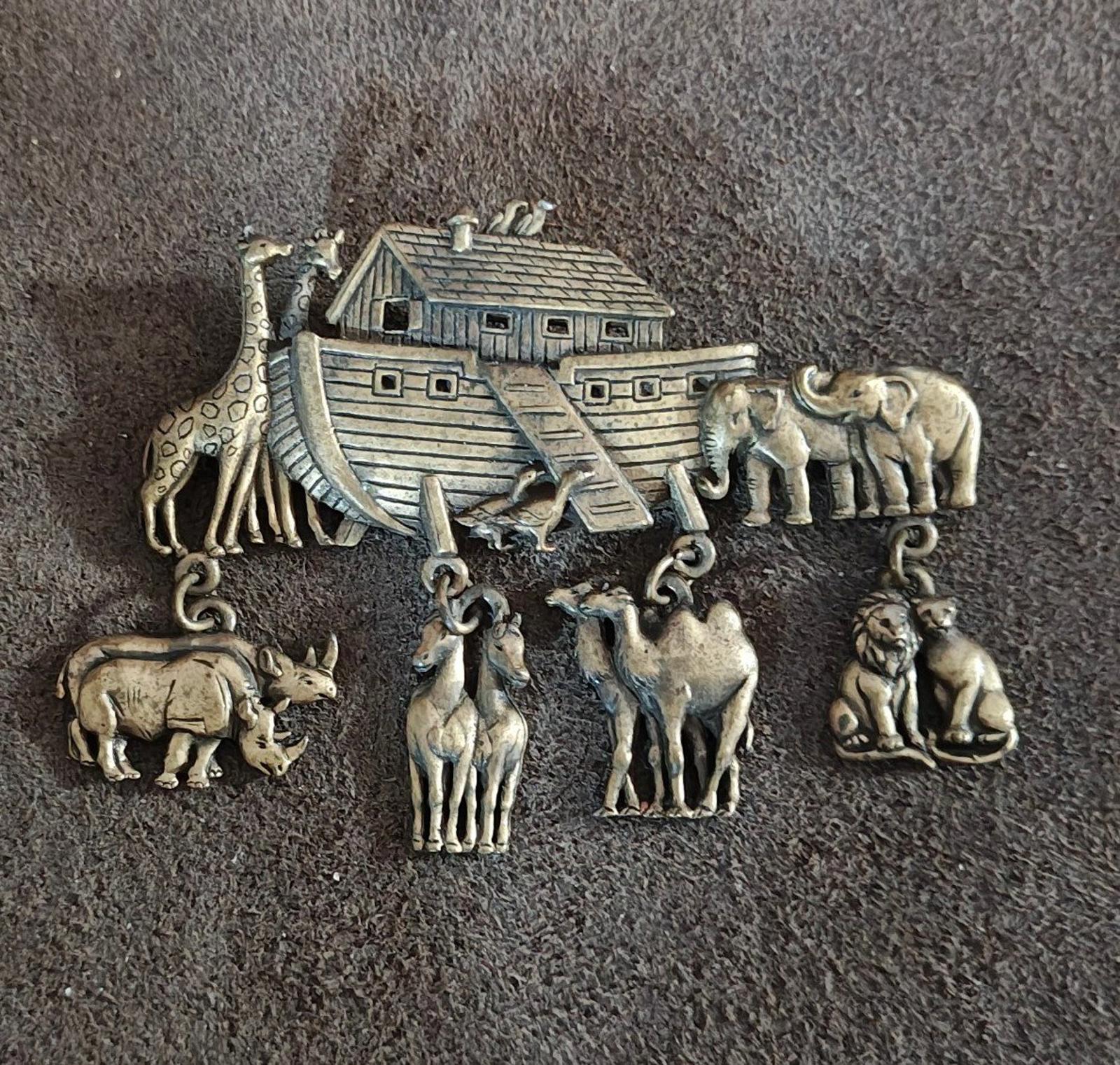 Gold Noah’s Ark brooch pin featuring ark with elephant and giraffe charms