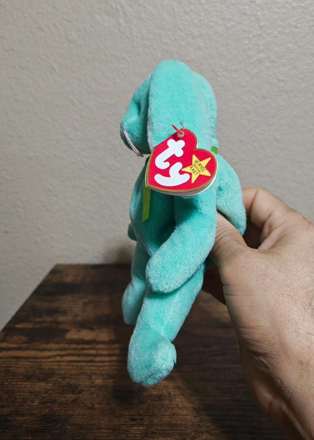 Teal plush bunny beanbag with Ty swing tag on side, long ears and feet visible