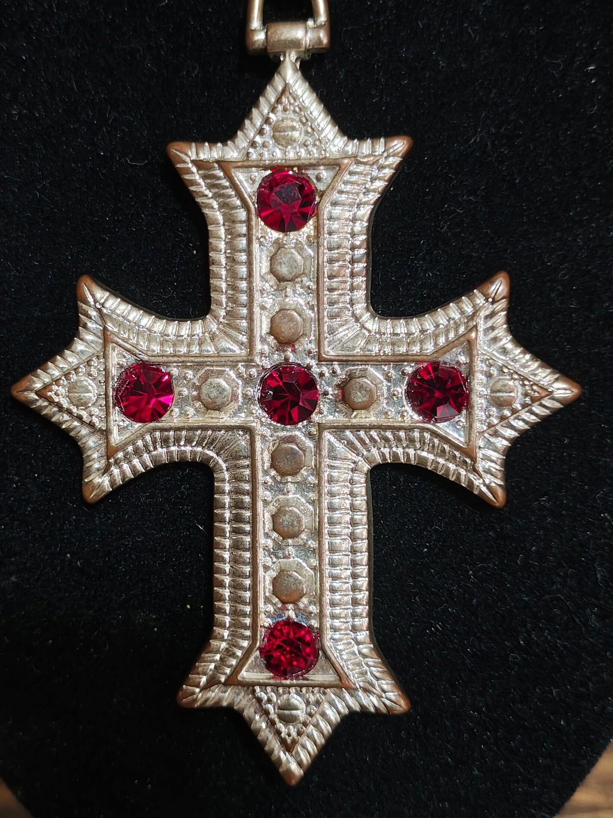 Silver tone cross pendant necklace with red rhinestone accents and central vertical row