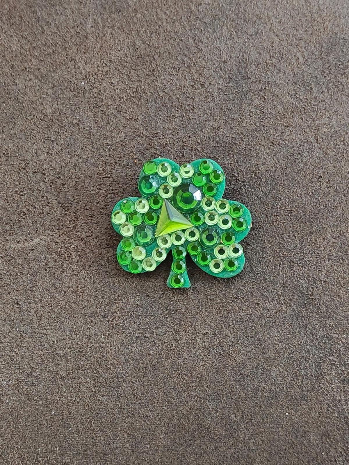 Green rhinestone shamrock brooch pin with sparkling stones and small dangling stem