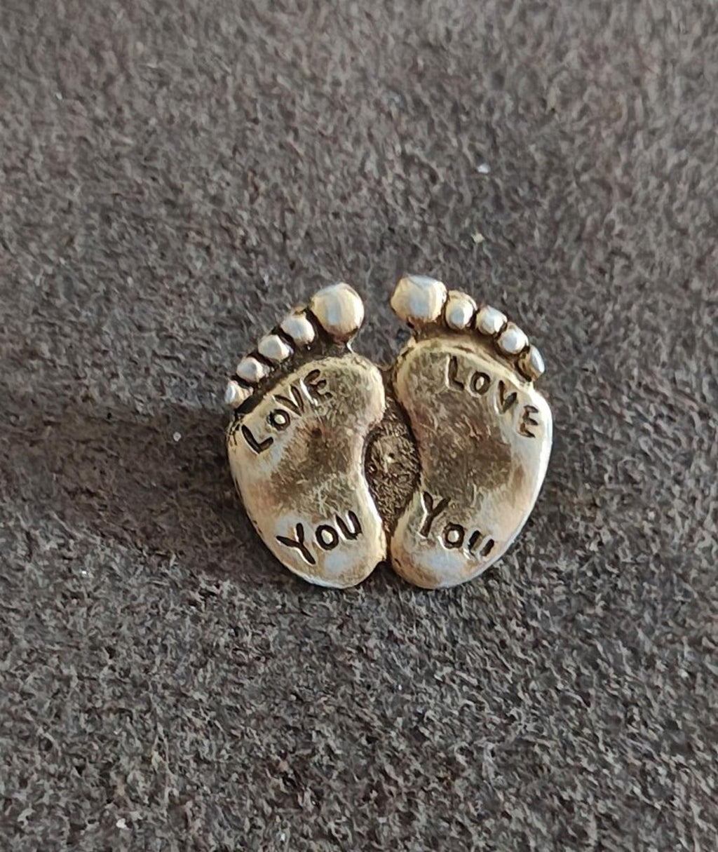 Gold-tone two-footprint brooch pin with "LOVE YOU" engraving and beaded border