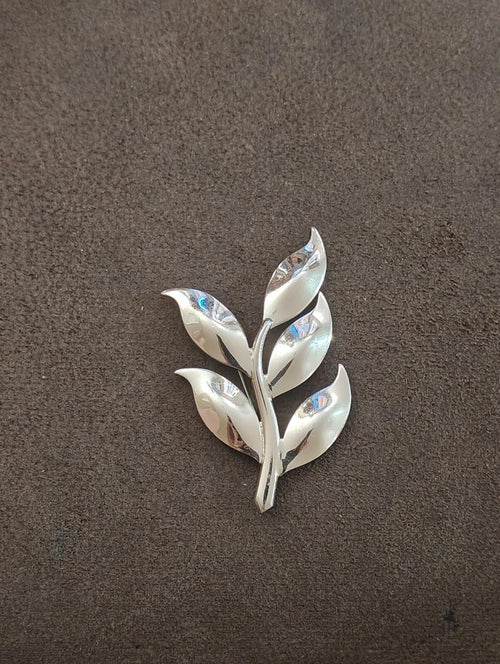 Modernist leaf brooch in silver tone, five petals with blue iridescent highlights.