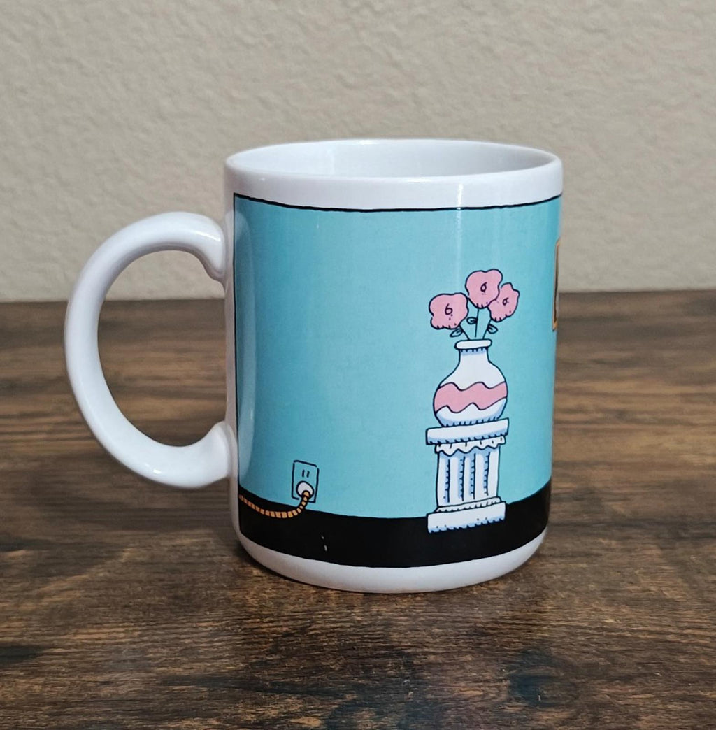 Blue ceramic mug with pink bunny character on stand and small VCR accessory
