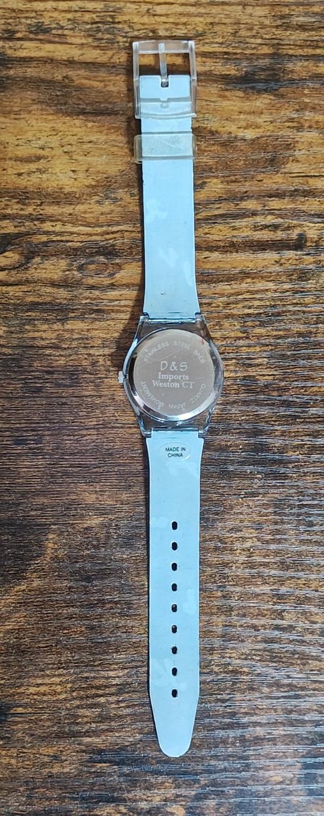 Unisex teacher watch with silver caseback and long perforated blue strap with buckle
