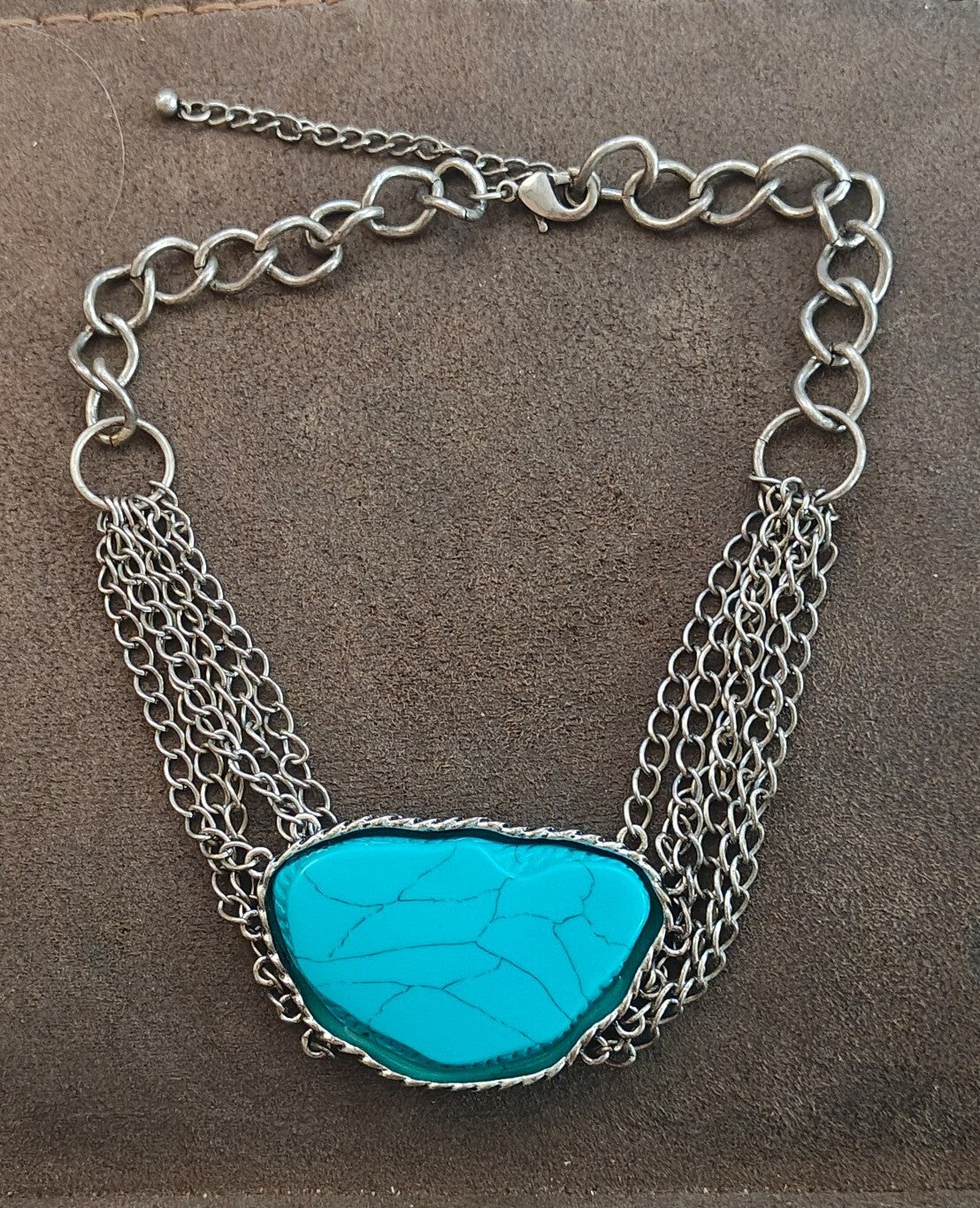Silver Tone Multi Strand Chain Statement Necklace With a Faux Turquoise Stone