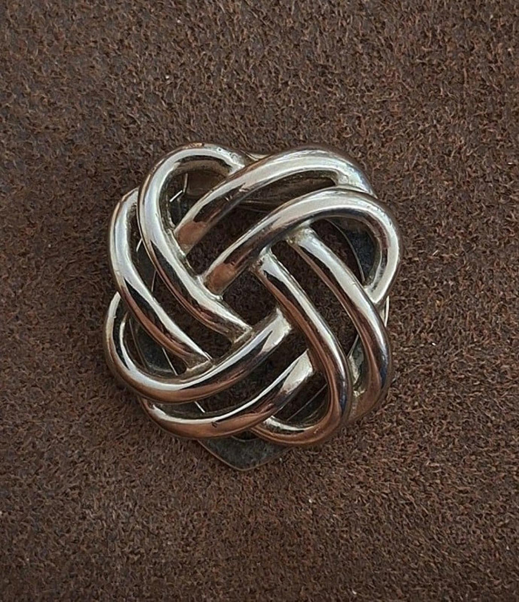 Silver interlocking love-knot scarf clip, rounded knot design with polished metal
