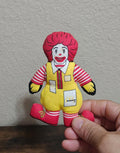 Ronald McDonald plush doll, red hair, striped shirt, yellow apron, red shoes