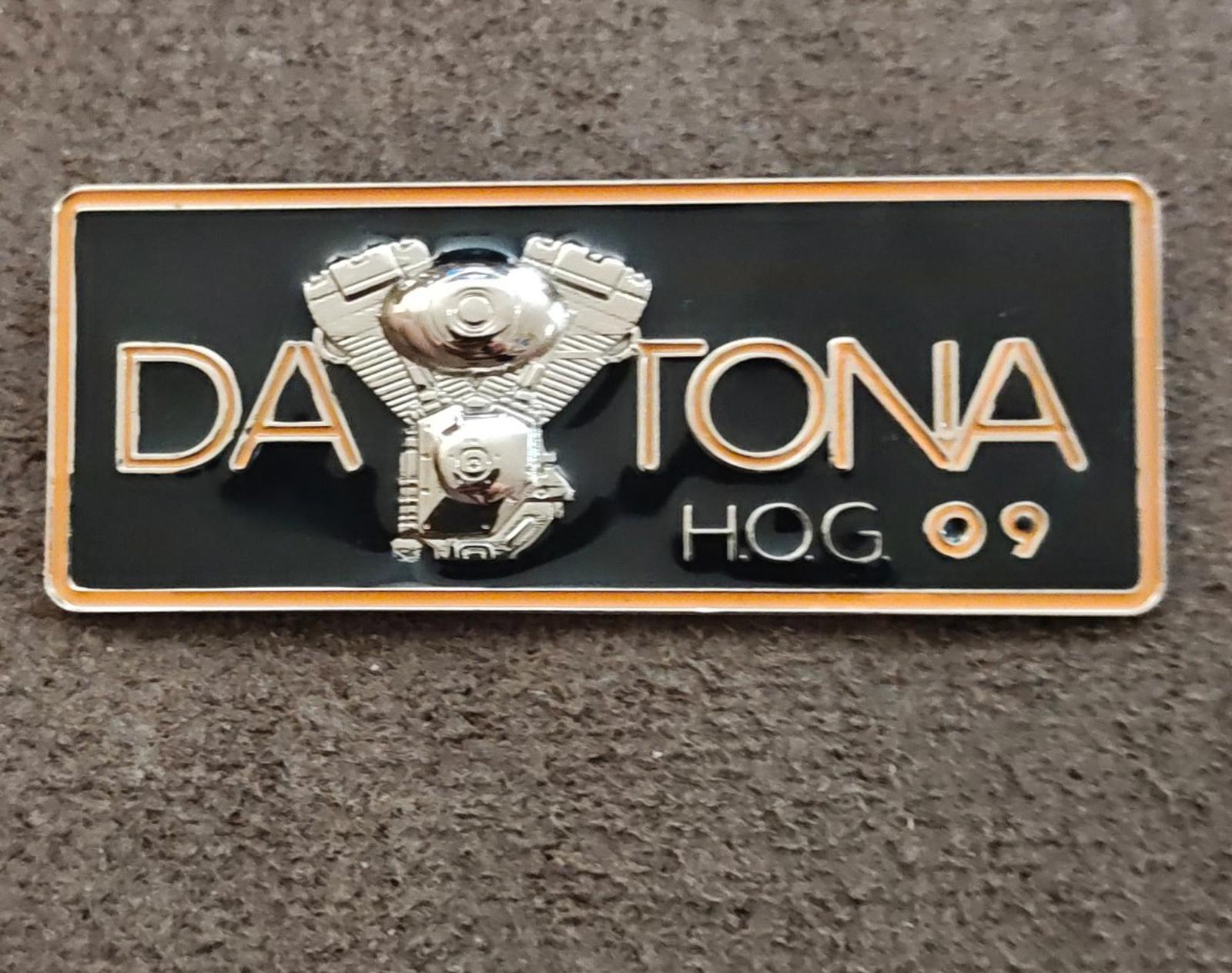 Black enamel Daytona H.O.G.09 pin with silver eagle details and gold outline border.