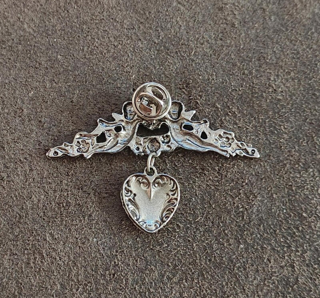 1980s Silver Tone Renaissance Style Cherub Brooch With Dangling Heart Charm