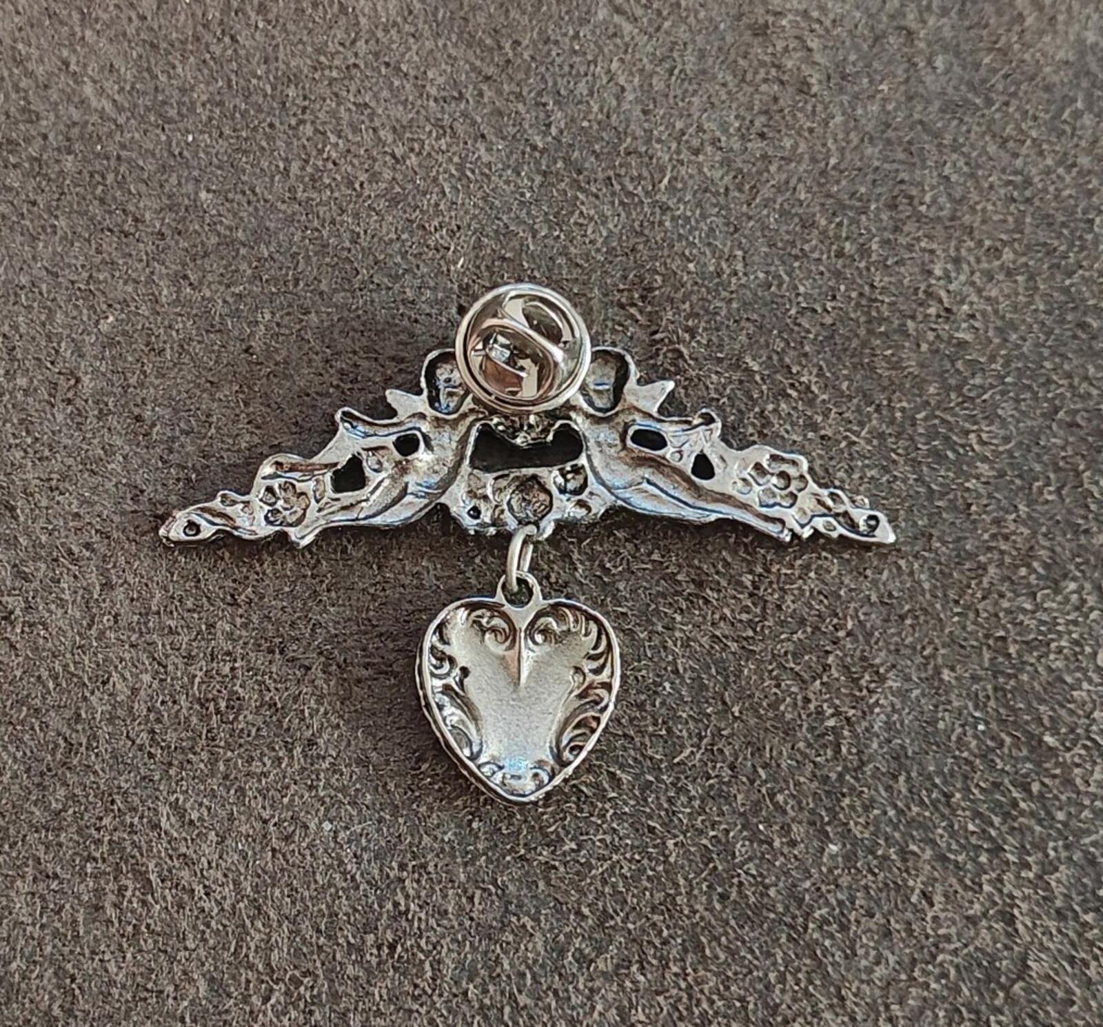 1980s Silver Tone Renaissance Style Cherub Brooch With Dangling Heart Charm