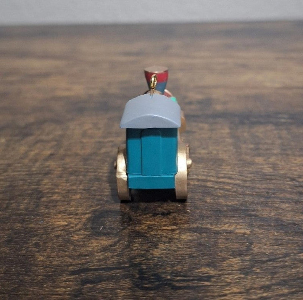 Blue train locomotive ornament, back view with small red roof emblem and hanging loop