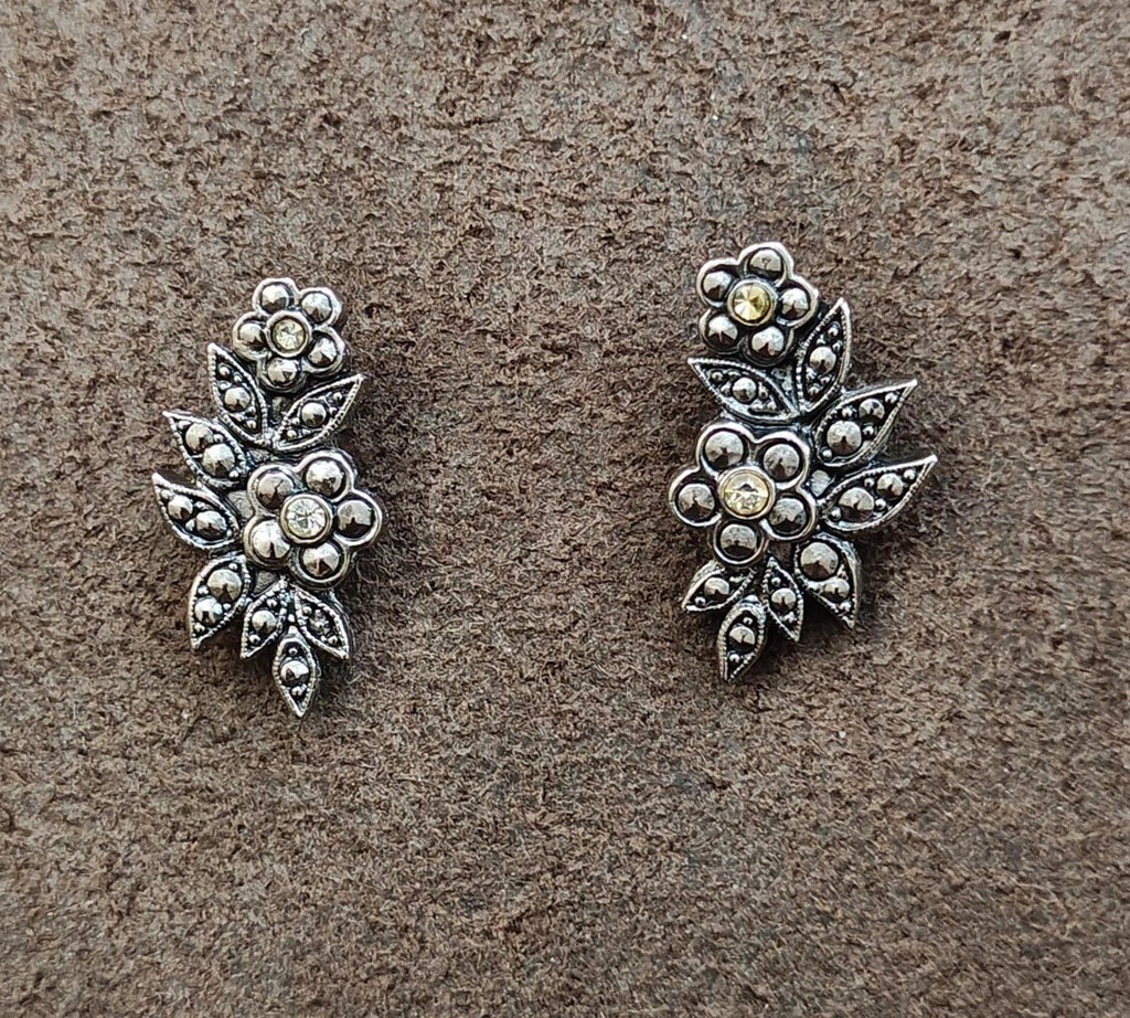 Silver tone floral leaf stud earrings with round rhinestones, two matching pairs