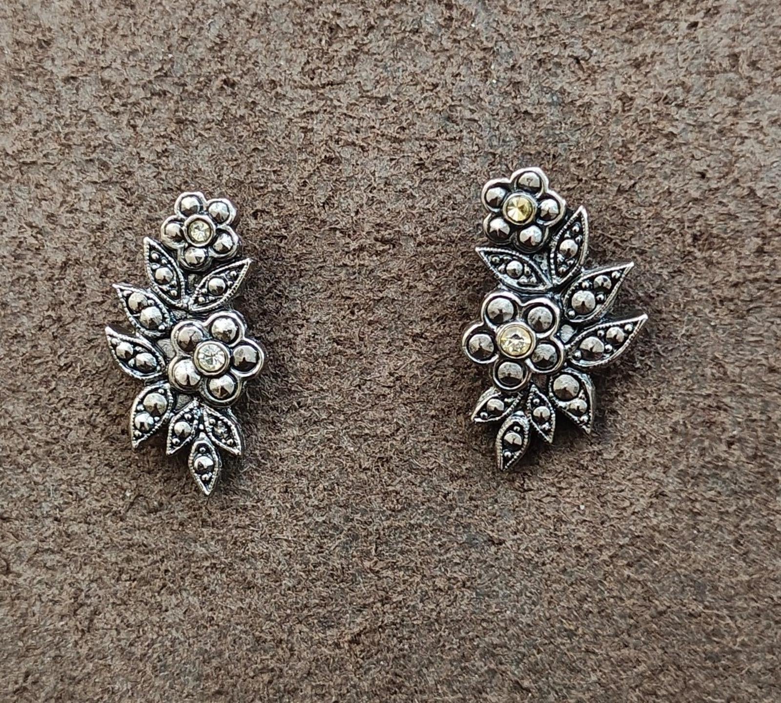 Silver tone floral leaf stud earrings with round rhinestones, two matching pairs