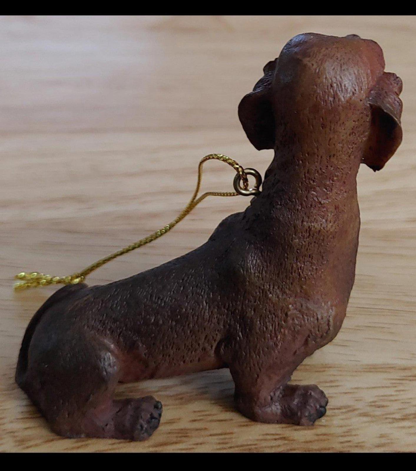 Chocolate brown dachshund ornament figurine, side profile, with gold hanging cord