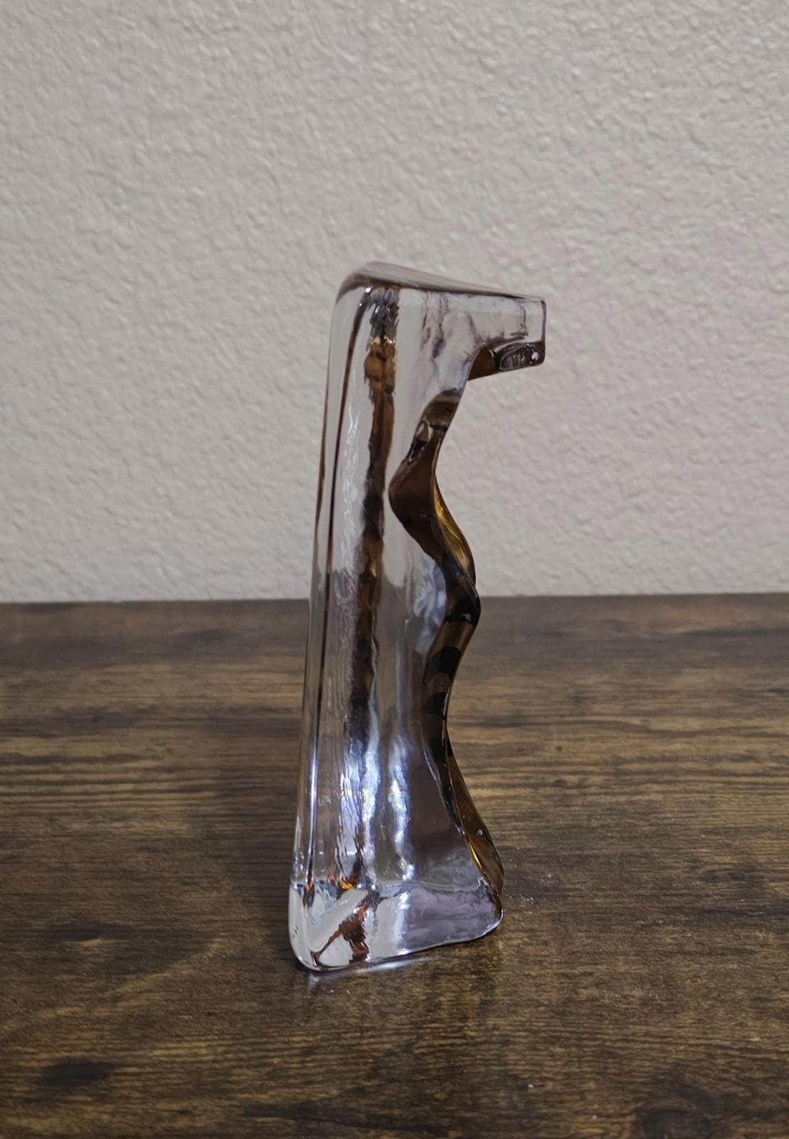 Clear cat paperweight figurine viewed from side, gold tabby face in block