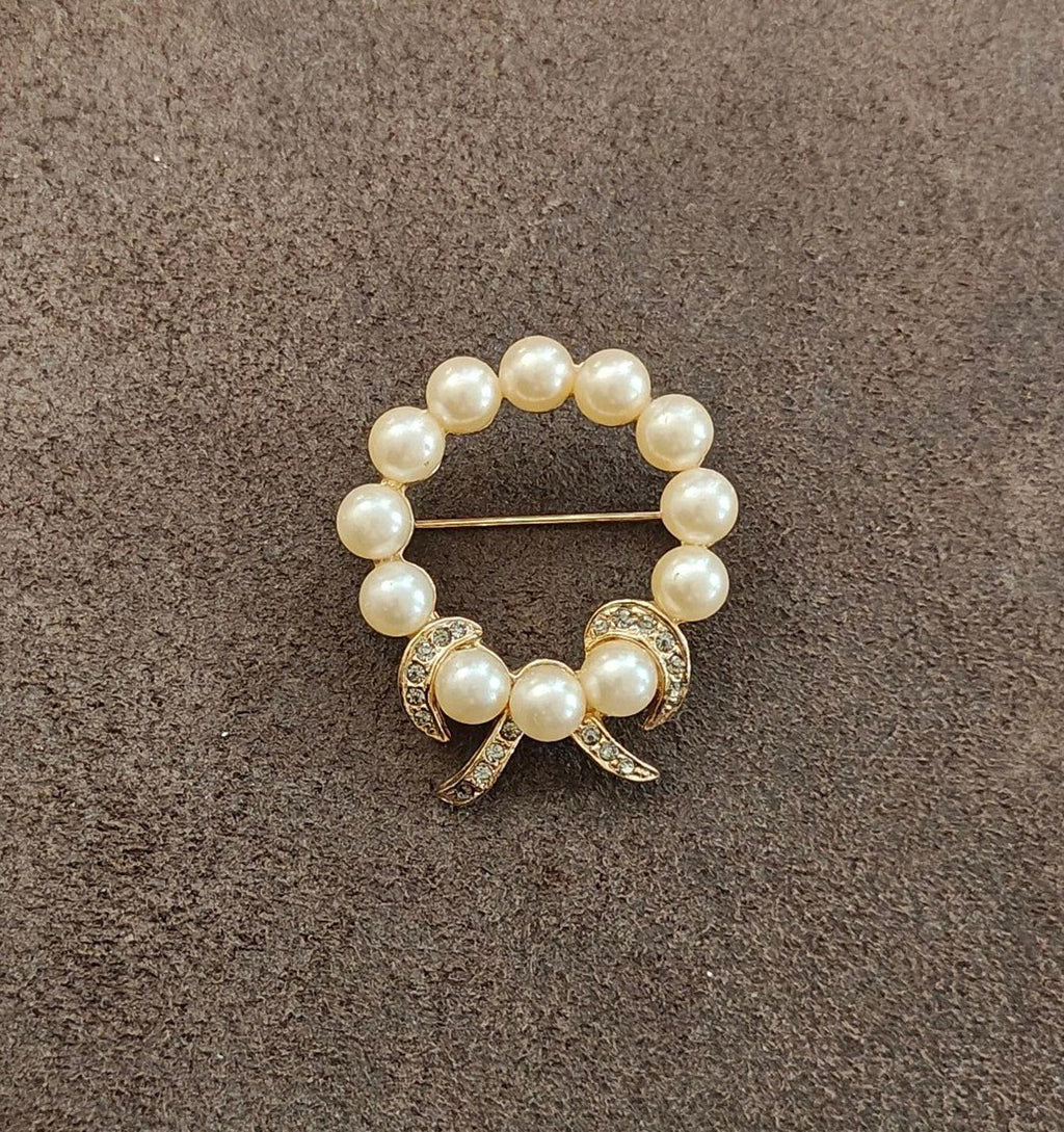 Gold-tone faux pearl wreath bow brooch with curled ribbon bow ends and pin back
