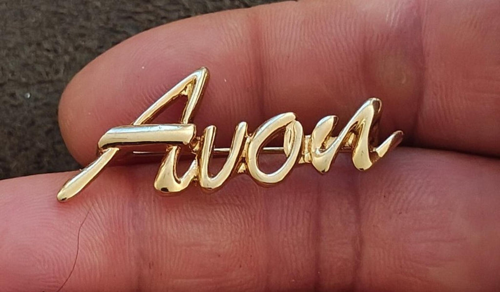 1980s/90s  Avon Gold Tone Cursive Logo Pin