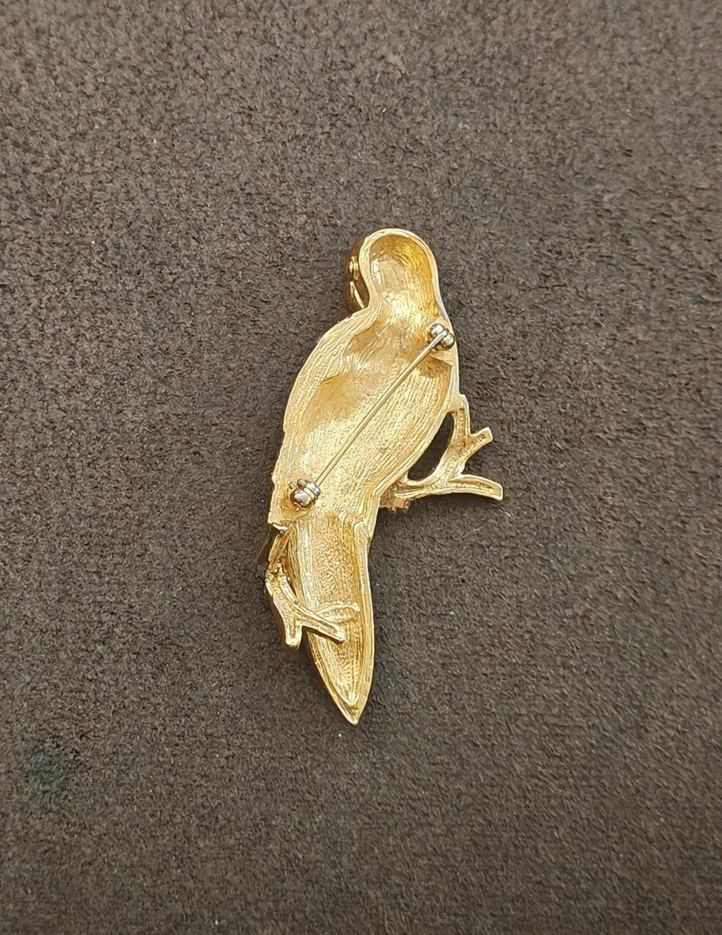 Gold tone bird brooch, back view with textured feathers and small rhinestone details