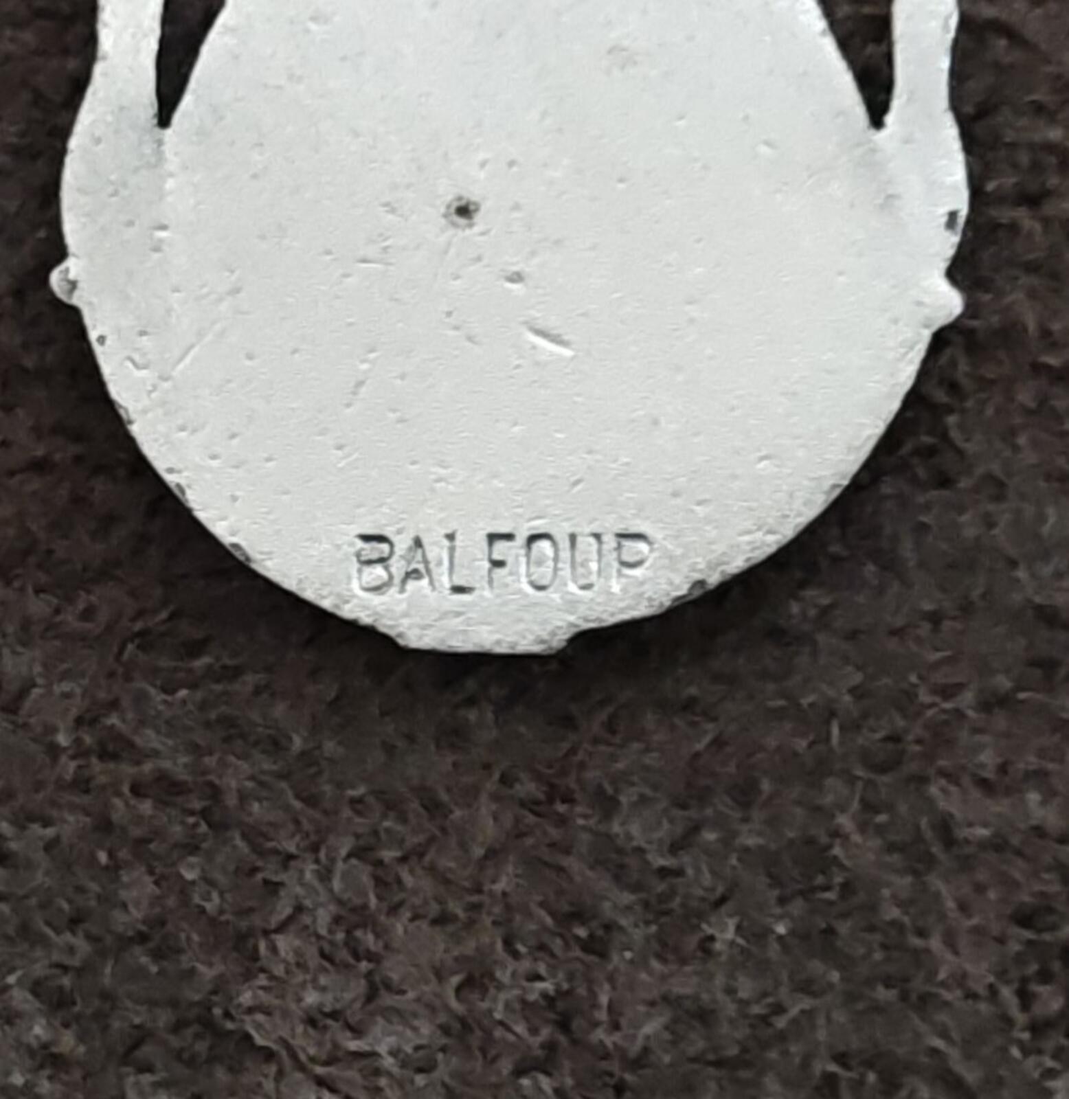 Round back charm with stamped text logo