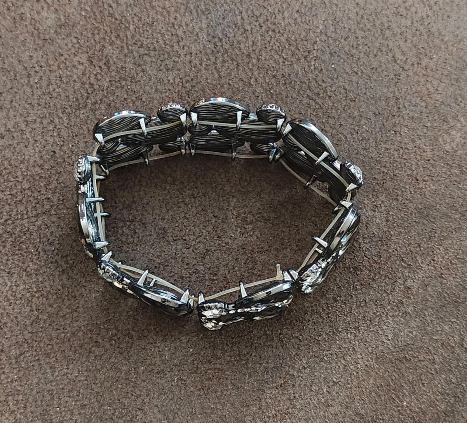 Black rhinestone stretch bracelet shown from the back with shiny metal bead-like rows