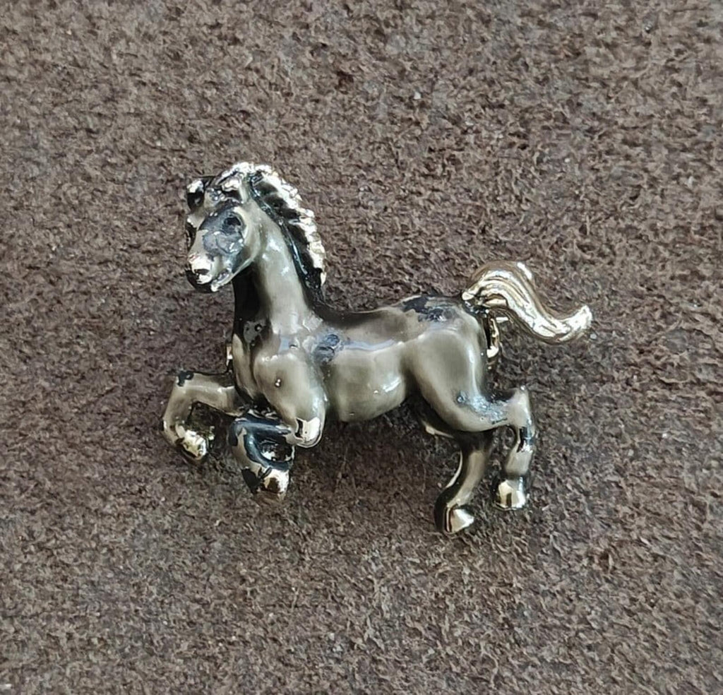 Prancing stallion brooch with silver-tone finish and gray-black enamel body