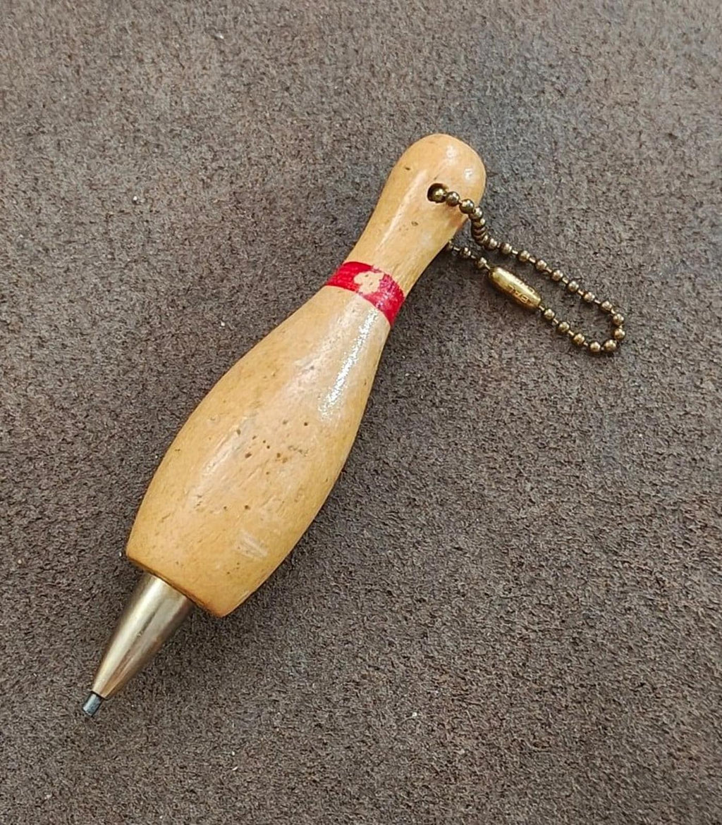 Beige wooden bowling pin keychain pencil with red band and dangling bead chain