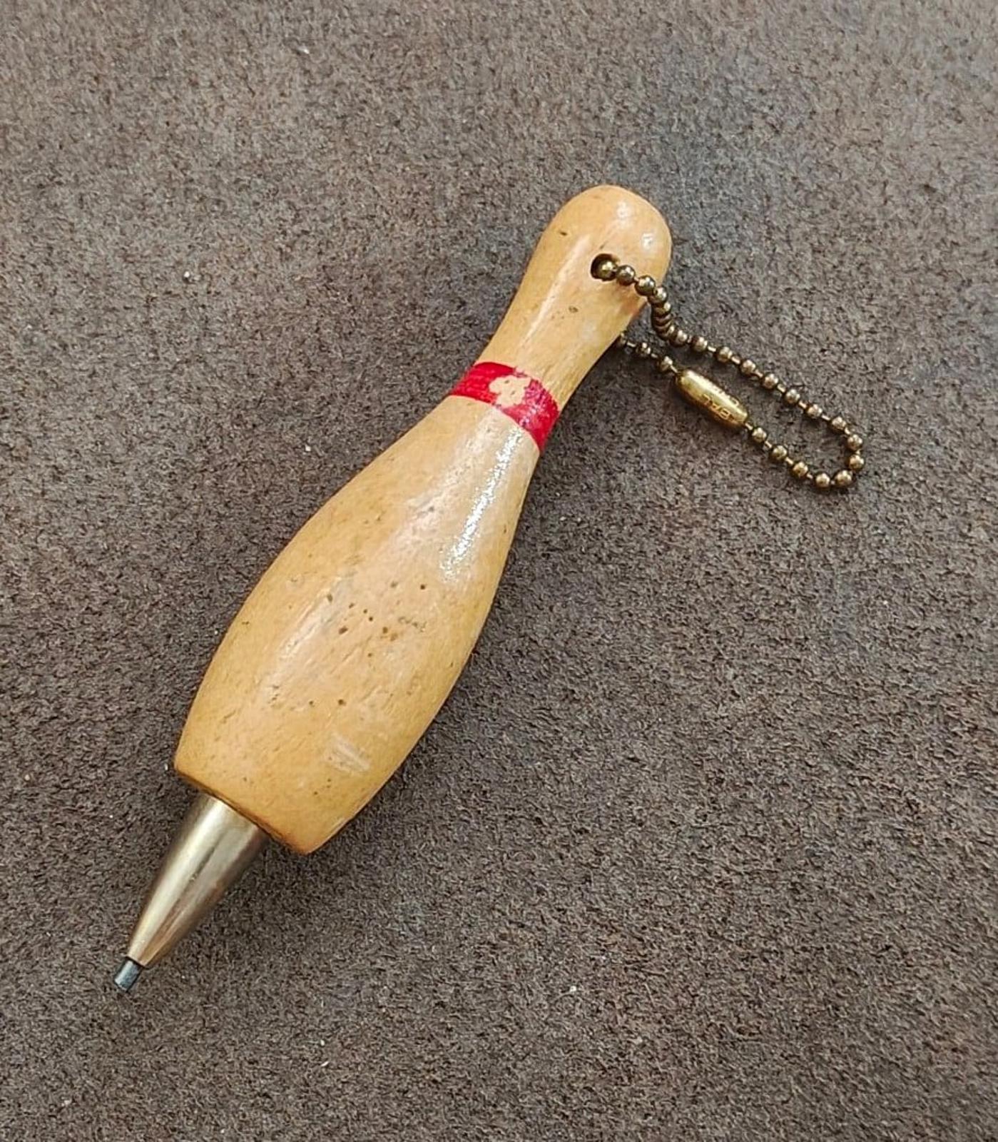 Beige wooden bowling pin keychain pencil with red band and dangling bead chain