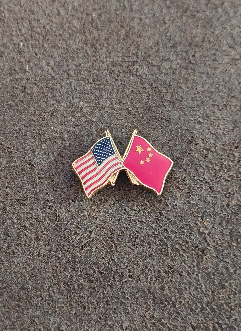 Small friendship flag enamel pin with crossed US and pink China flags, gold tone hardware.