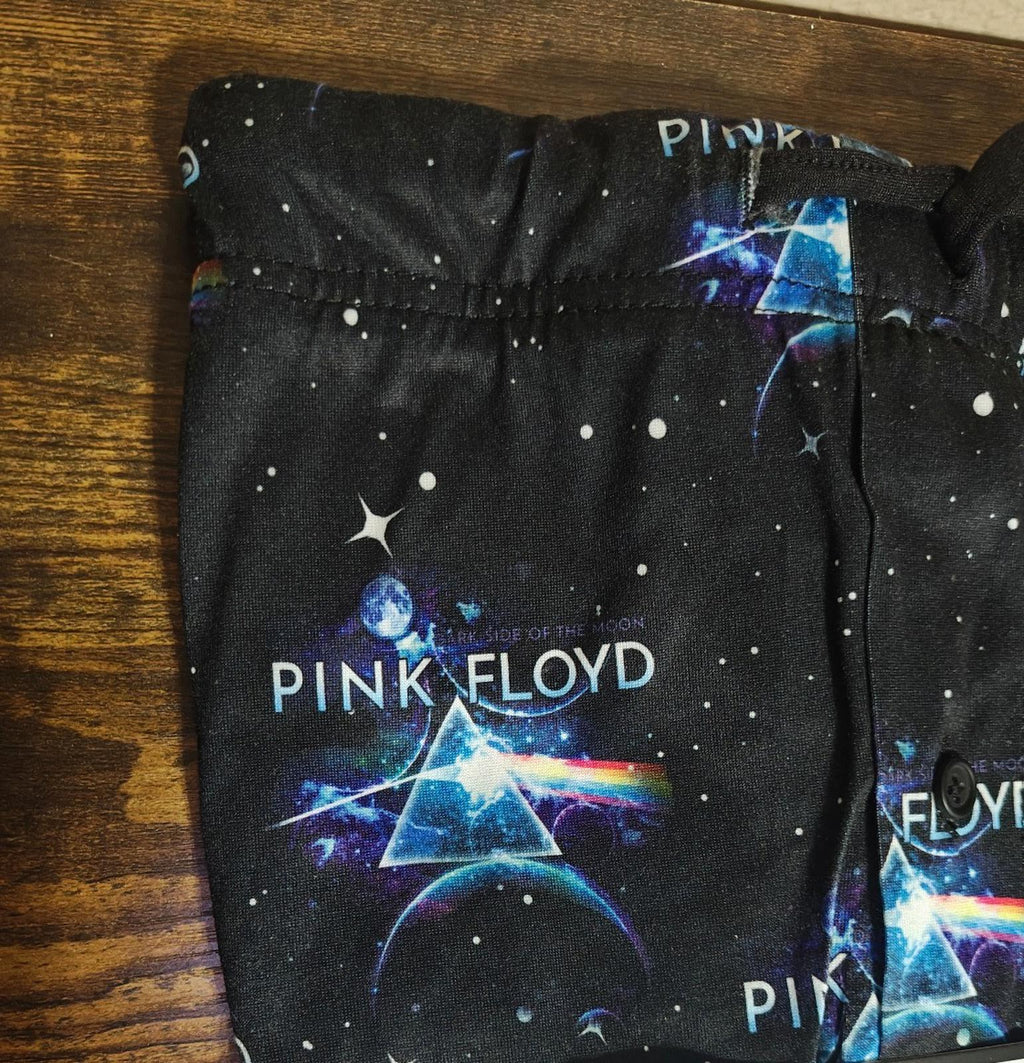 Black sleep pant fabric with blue and pink cosmic graphic and stars