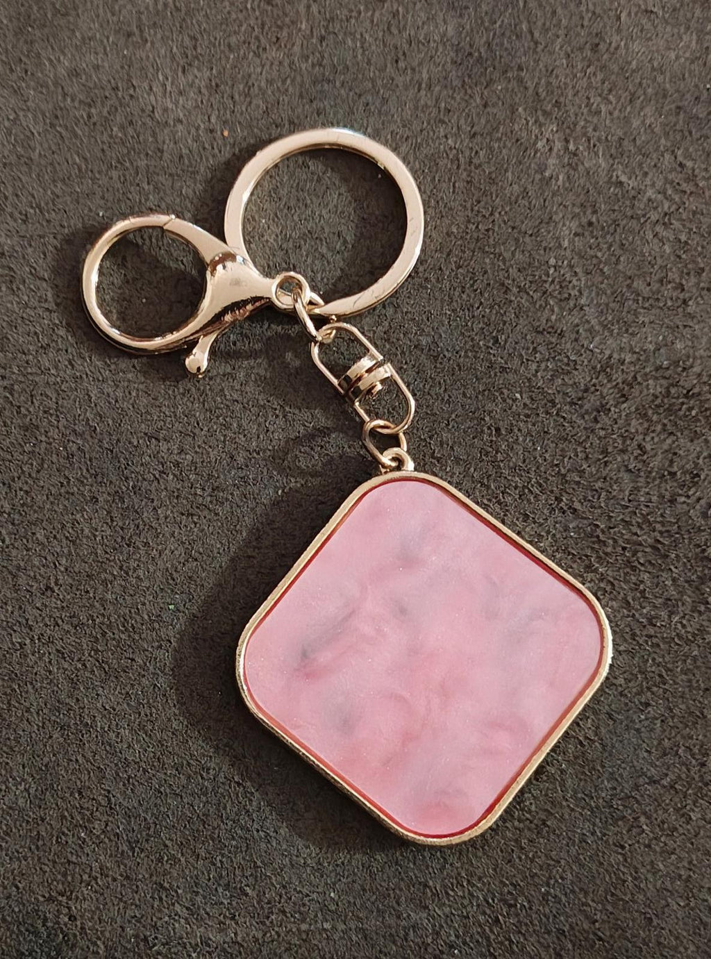 Gold-tone keychain with pink square resin pendant and ring clasp