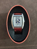 Square face Tom Brady game-time watch with brown leather strap and silver case.