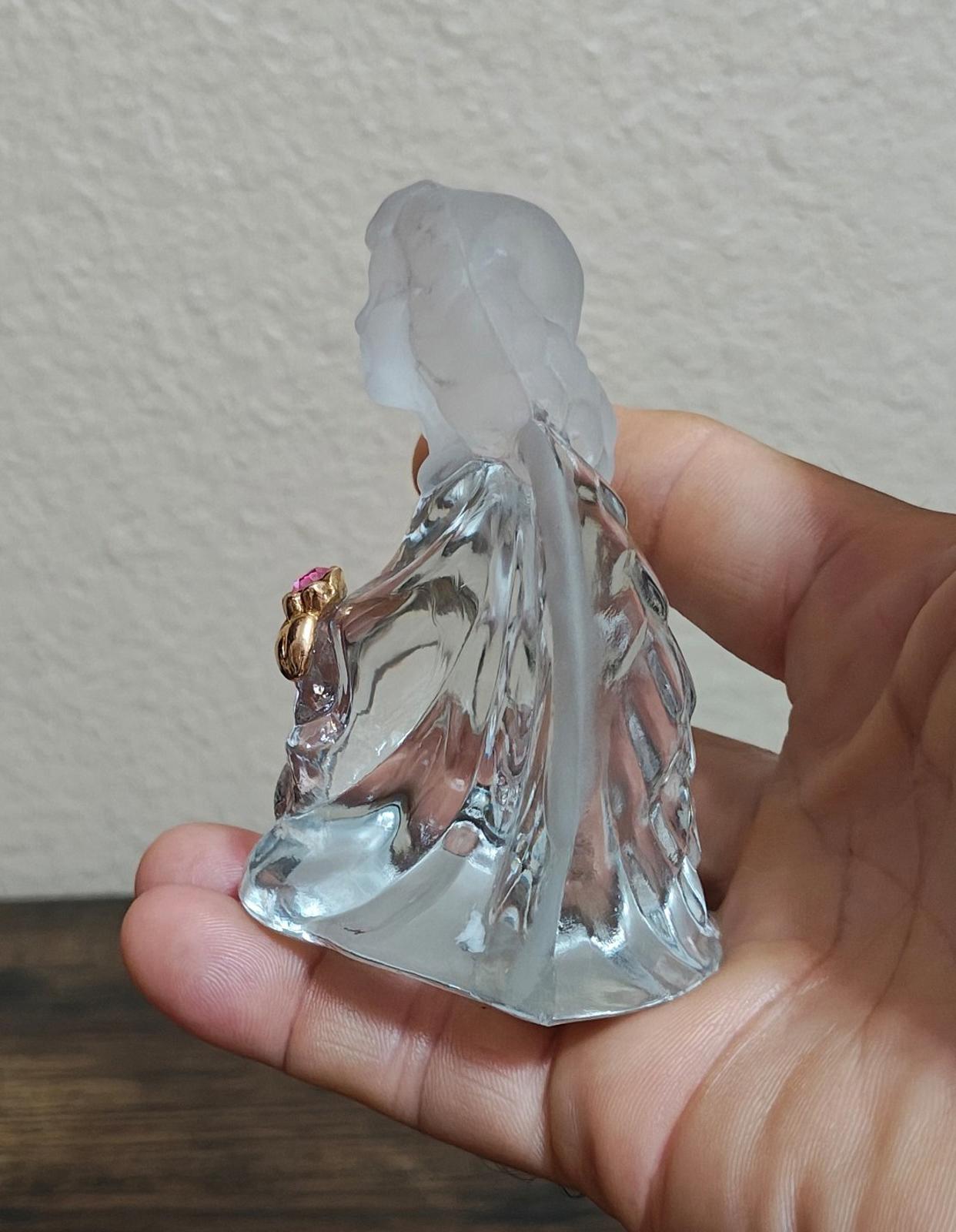 Clear glass guardian angel figurine side view, gold-tone flower base with pink gem