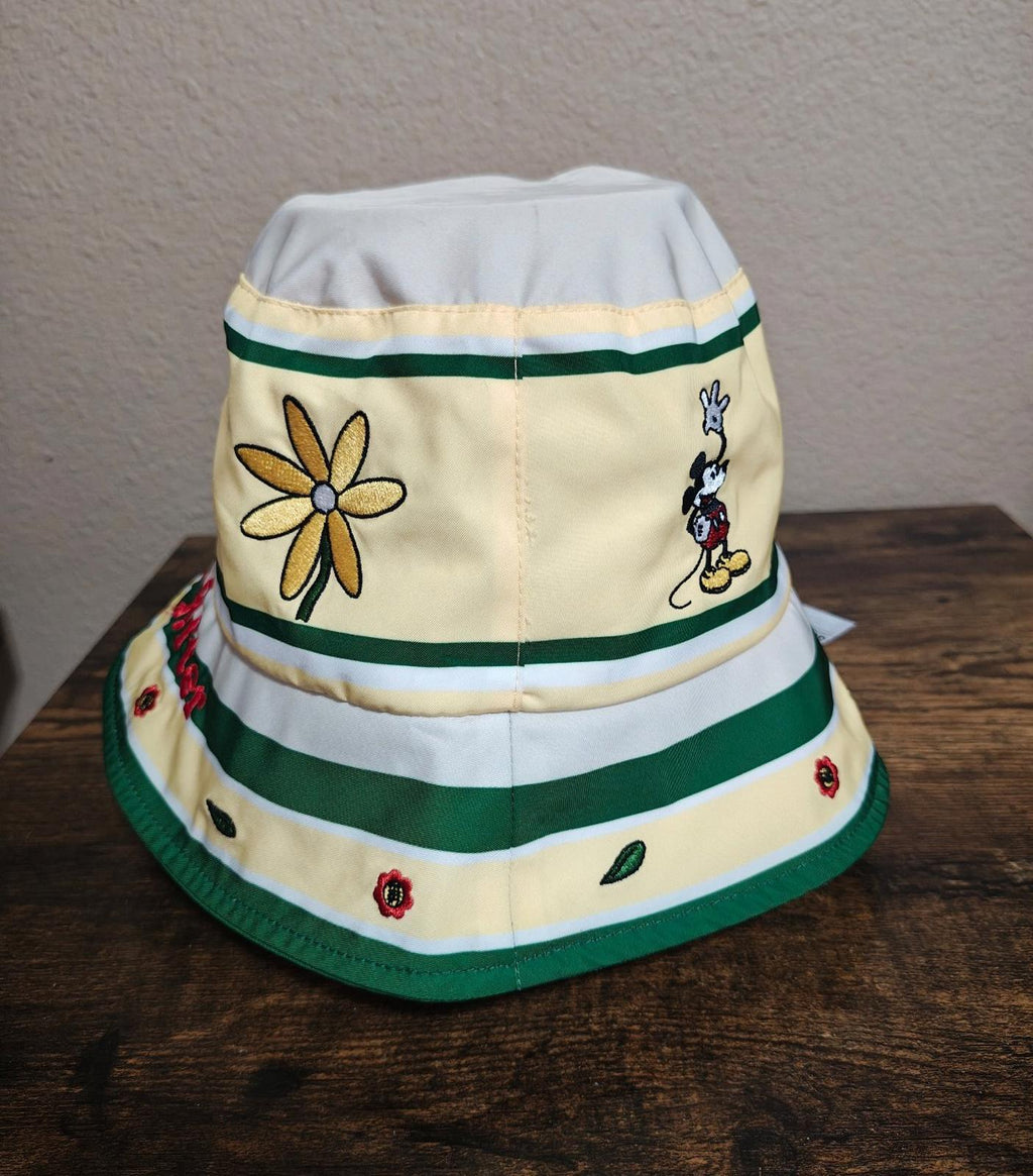 Cream bucket hat with green striped bands, daisy graphic, Mickey Mouse character patches