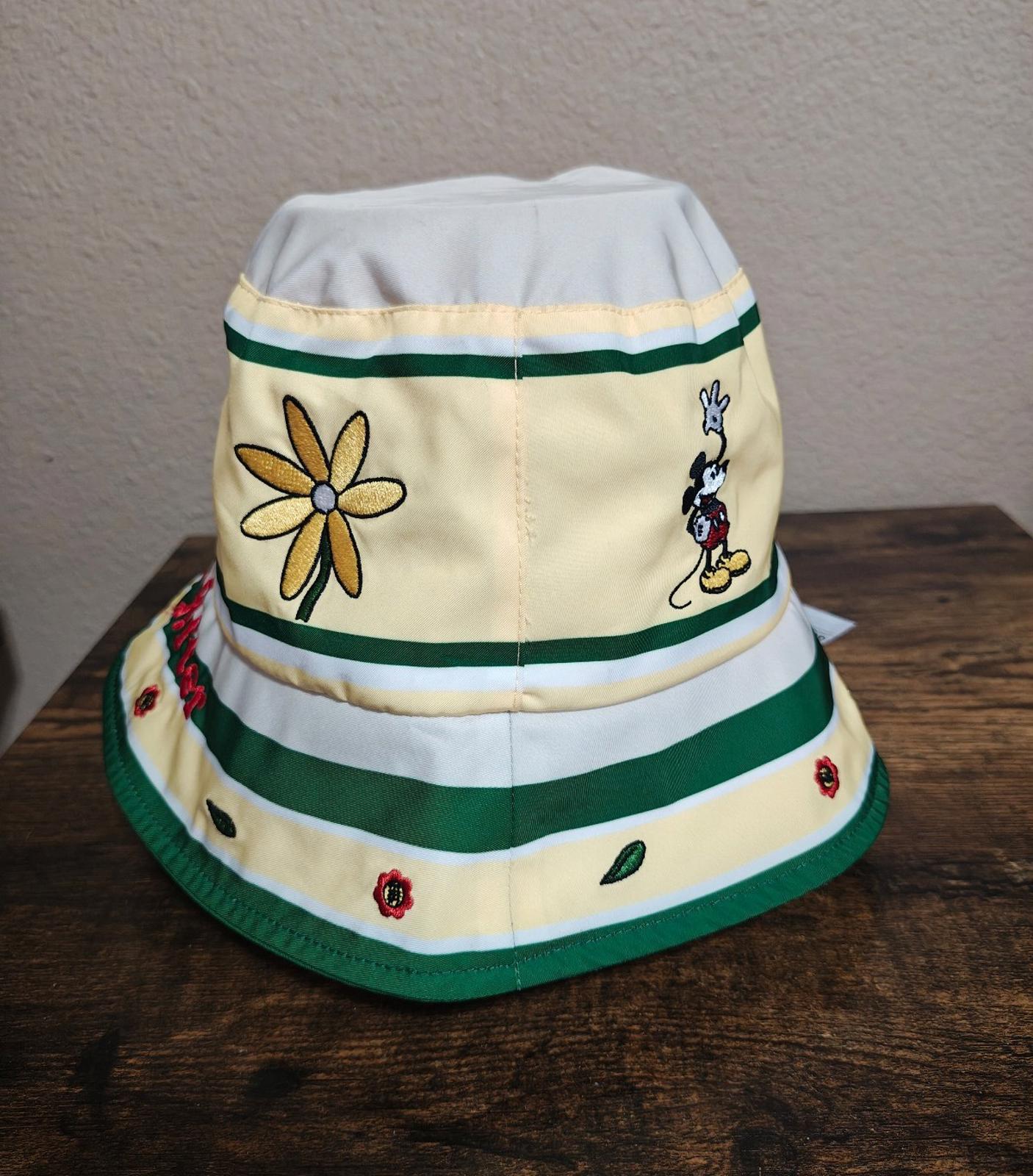 Cream bucket hat with green striped bands, daisy graphic, Mickey Mouse character patches