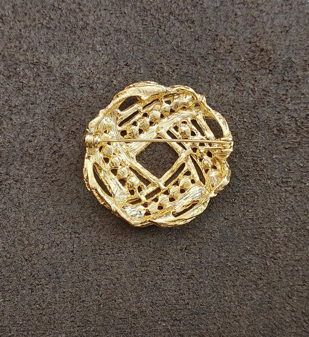 Gold-tone filigree brooch with faux pearl detailing and intricate lattice cutouts