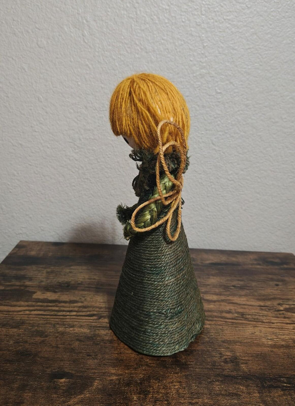 Handcrafted burlap angel tree topper, back view with dark green dress and looped ties