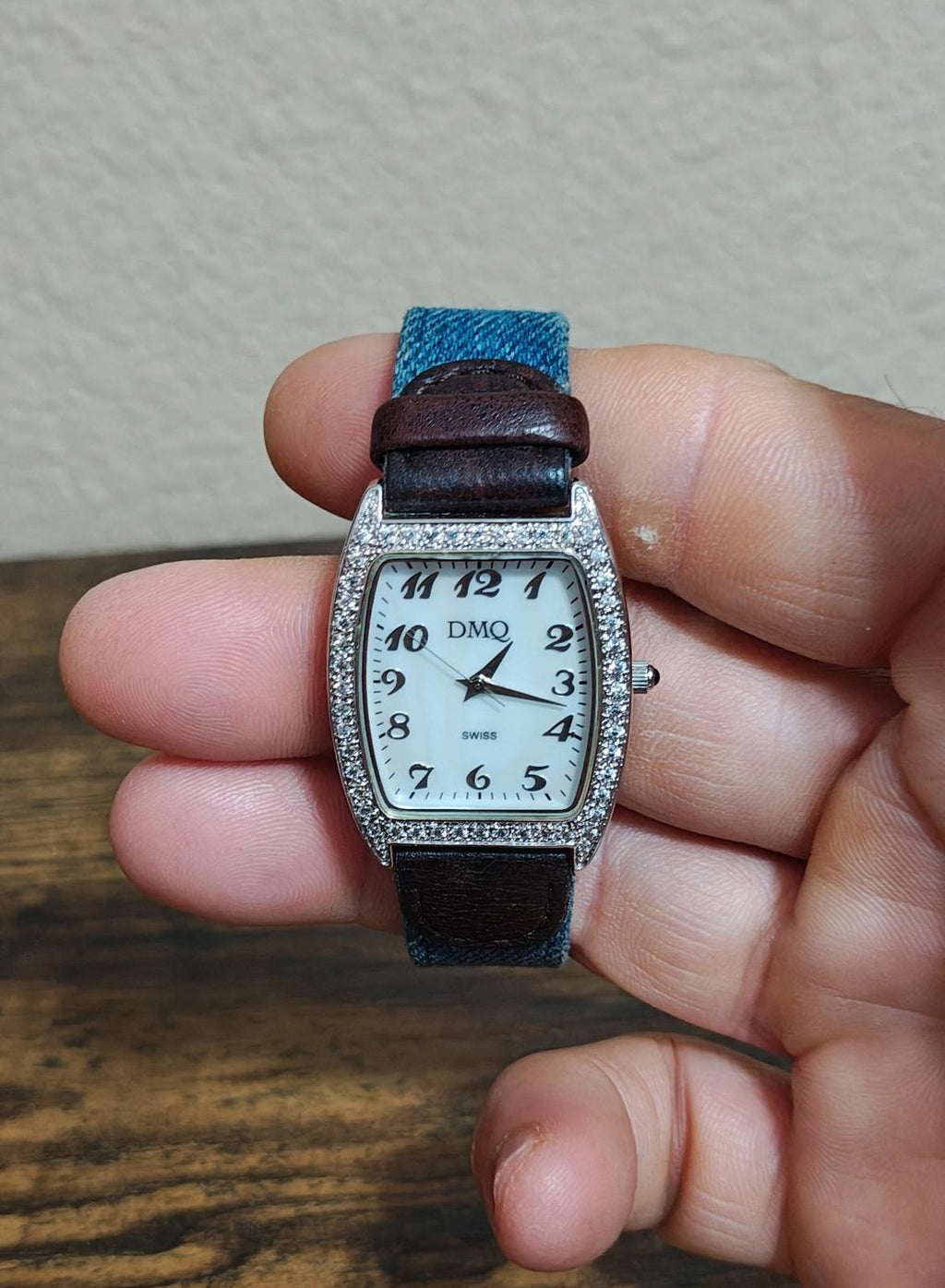 Ladies quartz watch with rectangular white dial, sparkling crystal bezel, blue strap, DMQ logo