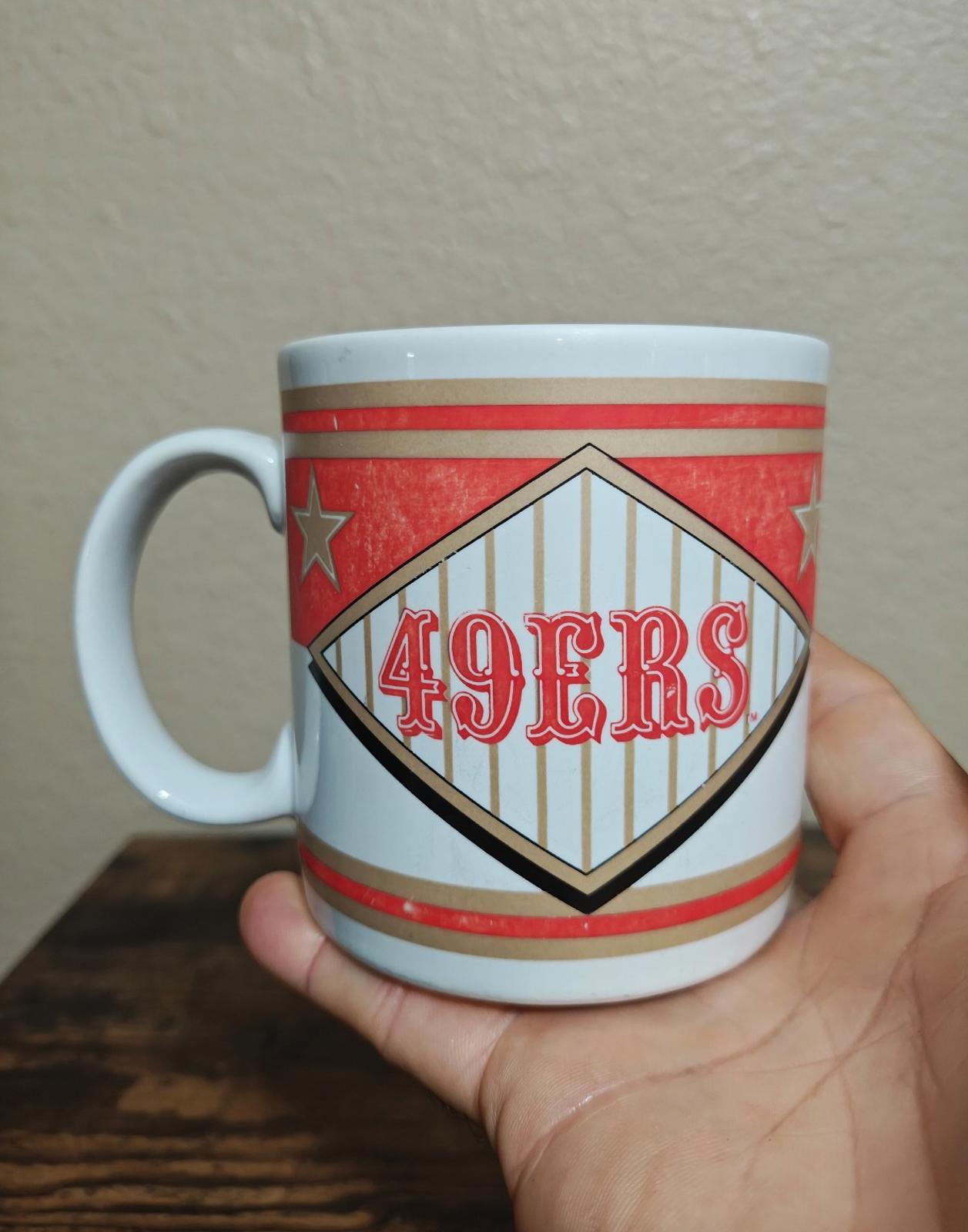 San Francisco 49ers diamond logo mug with red star accents and striped pattern.