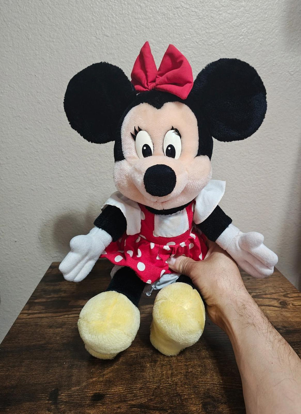 Minnie Mouse plush doll with red bow, red polka-dot dress, white collar, yellow feet